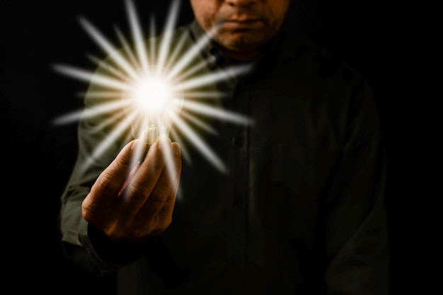 A man holding a light bulb is the concept of the startup that drives global business