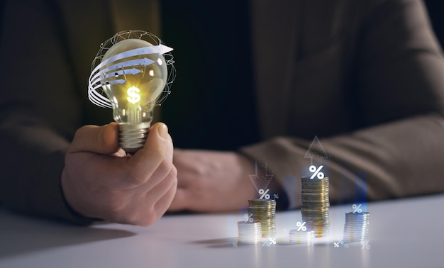 A man holding a light bulb with a percent sign on it