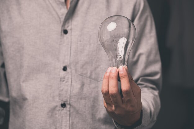 A man holding a light bulb