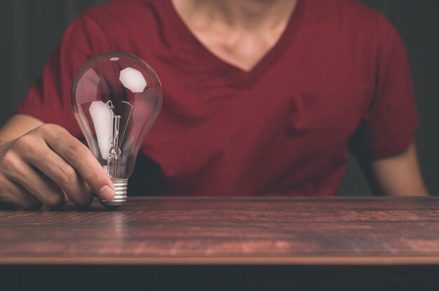 A man holding a light bulb