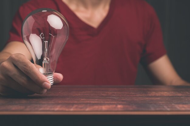 A man holding a light bulb