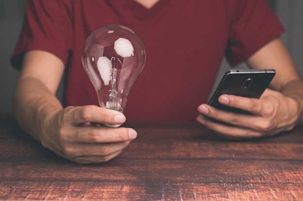 A man holding a light bulb