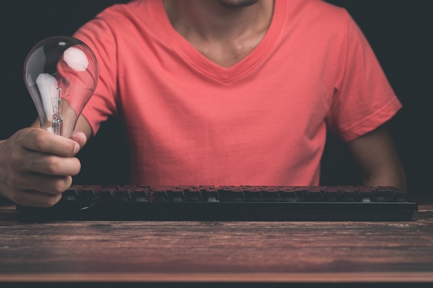 A man holding a light bulb