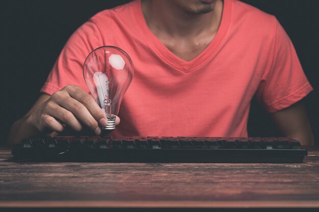 A man holding a light bulb