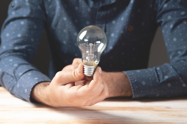 A man holding a light bulb