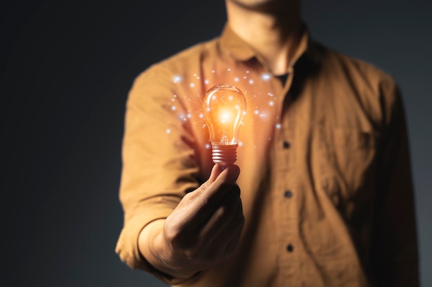 Man holding light bulbs ideas of new ideas with innovative technology and creativity