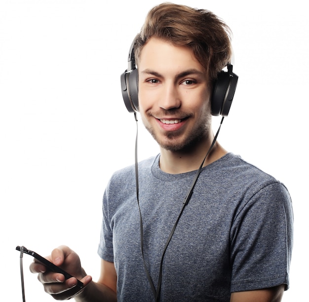 Man holding mobile phone and lictening to music over white backg