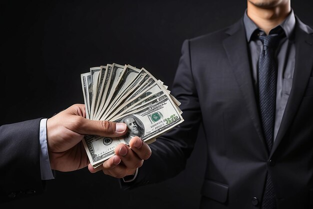 Photo man holding money in hand at black background man receive a lot money from trading business success concept