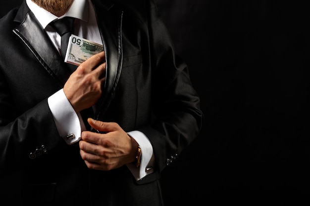 Photo man holding money in hand at black