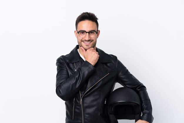 Man holding a motorcycle helmet over isolated wall