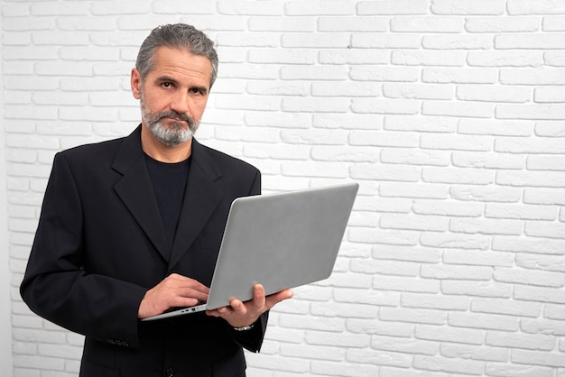 Man holding notebook, posing in studio.