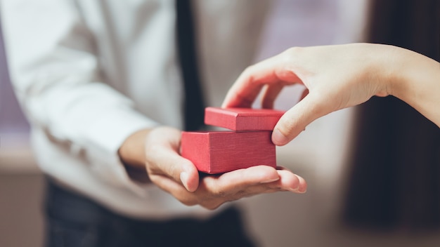 Man holding open the empty red gift box. 