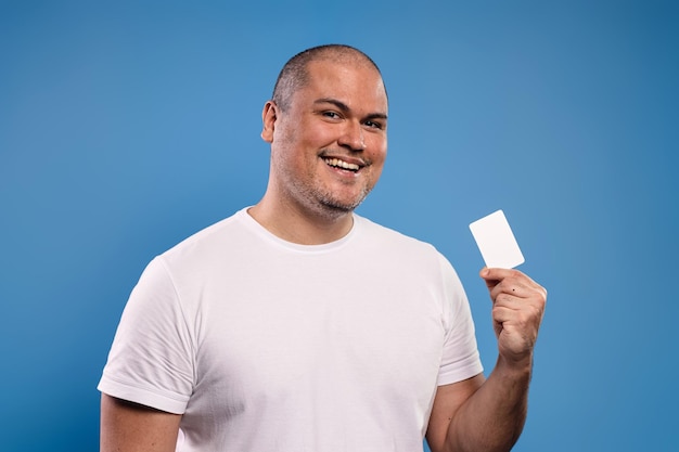 Man holding a paper card and smiling