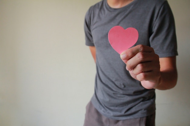 The man holding a paper heart.