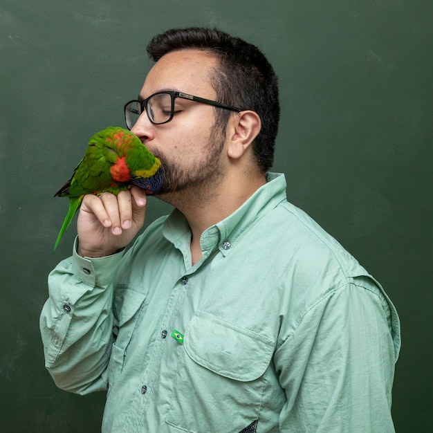 Man holding a Parrot Trichoglossus moluccanus