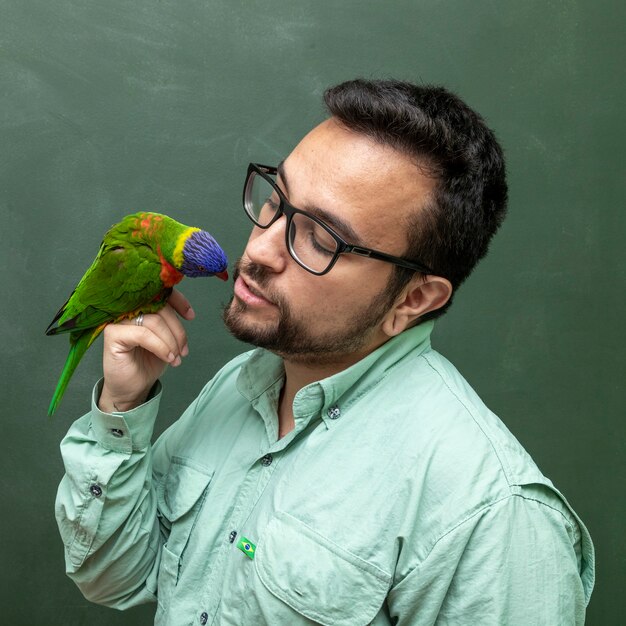 Man holding a Parrot Trichoglossus moluccanus