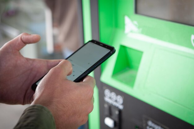 Man holding phone and using terminal