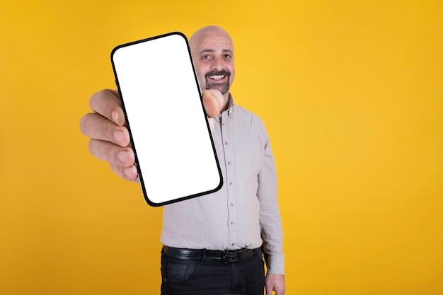 A man holding a phone with a blank screen advertisement concept idea mock up