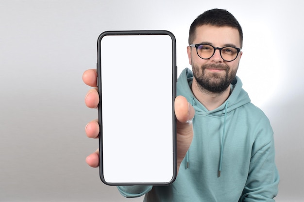 A man holding a phone with a blank screen