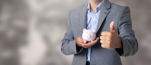 Man holding a piggy bank in his hand