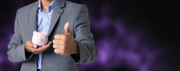 Man holding a piggy bank in his hand