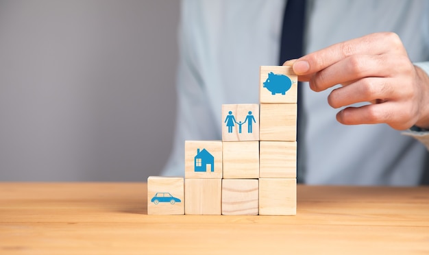 Man holding piggy bank icon on blocks