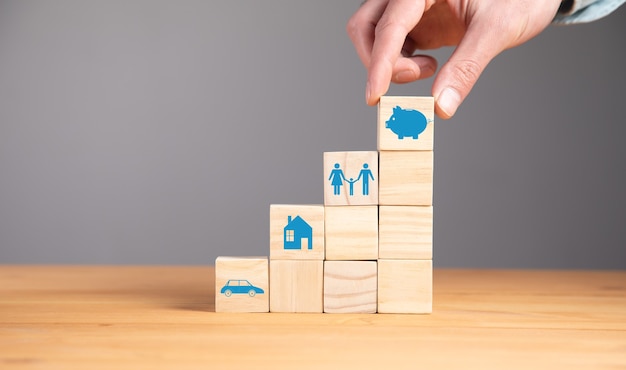 Man holding piggy bank icon on blocks