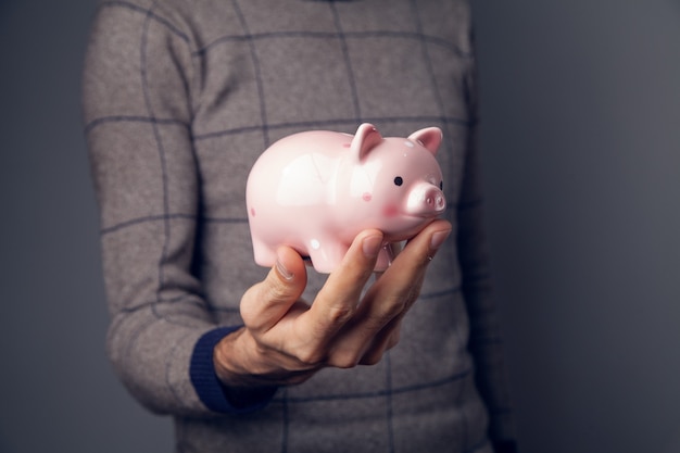 Man holding piggy bank