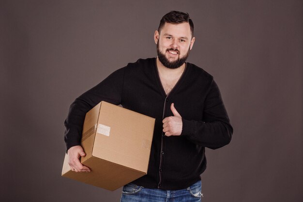 Man holding pile of cardboard boxes in front