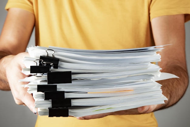 Man holding a pile of papers