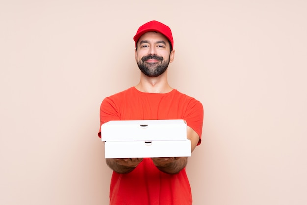 Man holding a pizza over isolated 