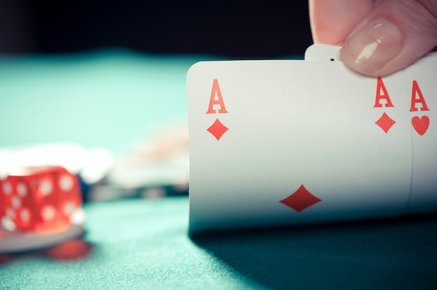 Man holding play card poker chips