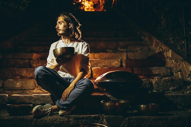 Man holding and playing a singing bowl tibetan bowl