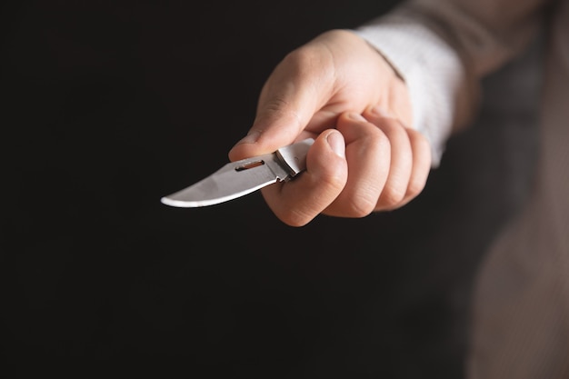 A man holding a pocket knife .