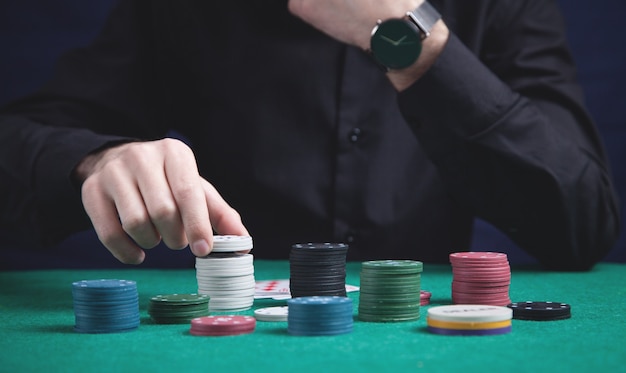 Man holding poker chips. Casino