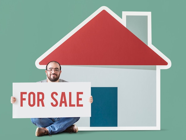 Man holding poster with house mockup