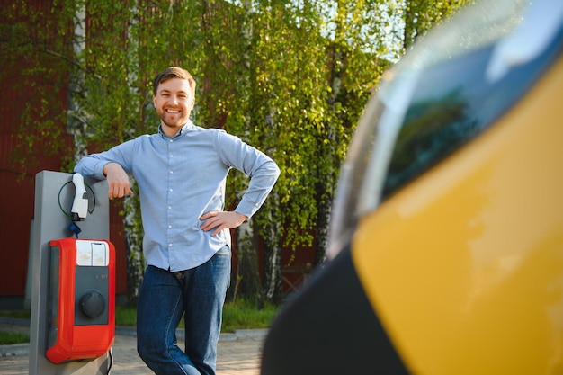 Man Holding Power Charging Cable For Electric Car