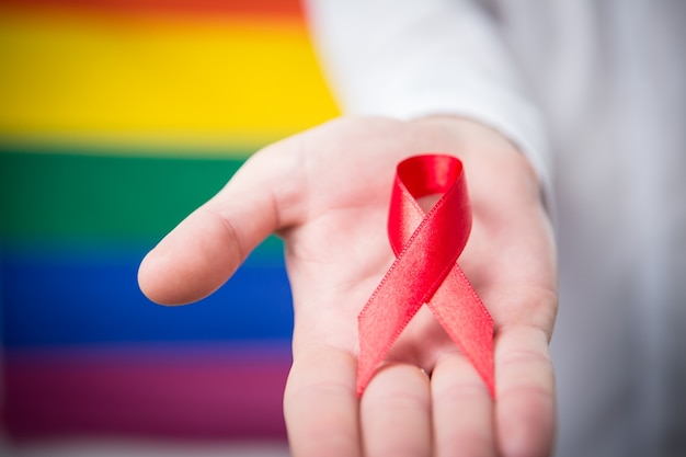 Man holding red awareness ribbon