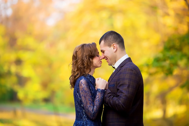 Man holding red box with ring making propose to his girlfriend outdoors.