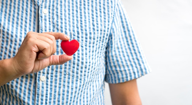 Man holding a red heart