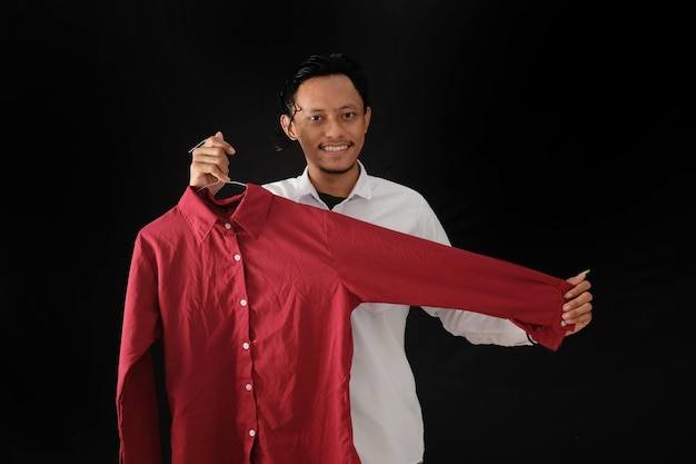 A man holding a red shirt that says'i'm a man '