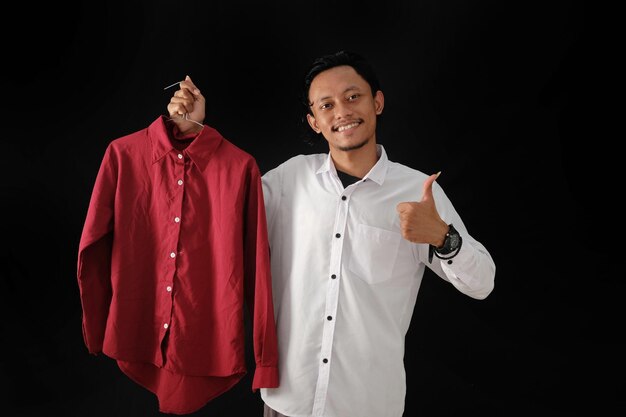 A man holding a red shirt that says'i'm not a man '