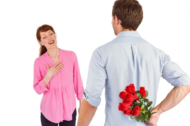 Man holding roses behind him