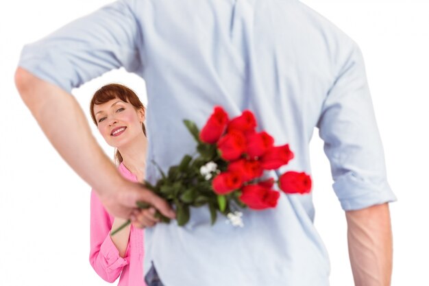 Man holding roses behind him