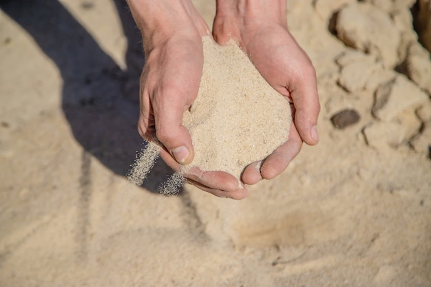 Man holding sand in his hands