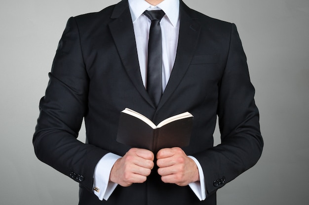 A man holding a schedule book