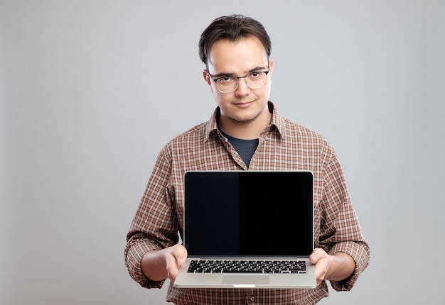 Man holding and showing laptop computer