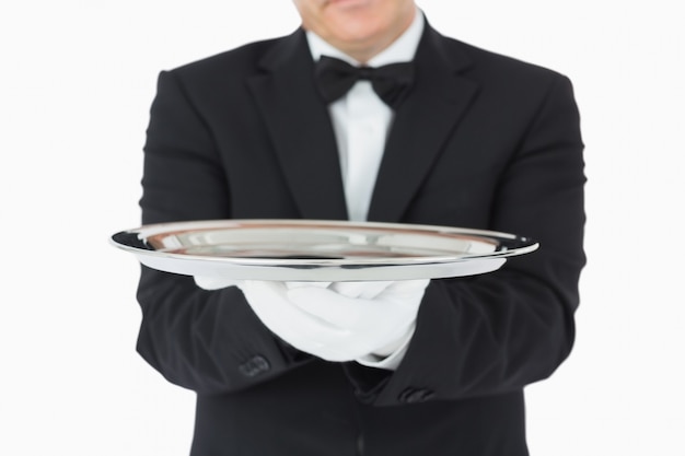 Man holding a silver tray with both hands