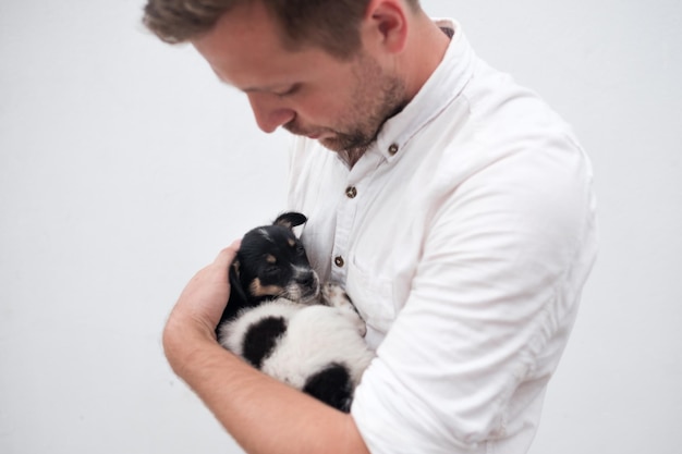 Man holding a small puppy in his hands