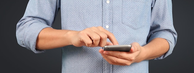 Man holding smartphone device and touching screen